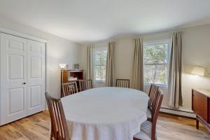 a dining room with a white table and chairs at Peace & Serenity in Falmouth