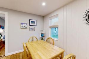a dining room with a wooden table and chairs at Seabreeze Escape in Barnstable