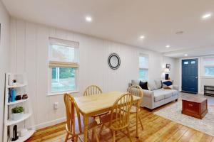 a living room with a table and a couch at Seabreeze Escape in Barnstable