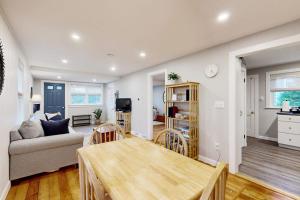 a living room with a couch and a table at Seabreeze Escape in Barnstable
