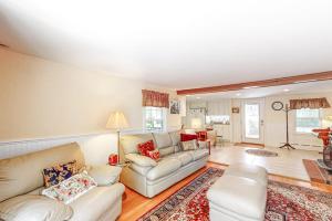 a living room with two couches and a rug at Falmouth Beachtown Getaway in Falmouth
