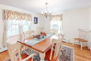 a dining room with a wooden table and chairs at Falmouth Beachtown Getaway in Falmouth
