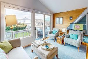 a living room filled with furniture and a large window at Bayview Bliss in Provincetown