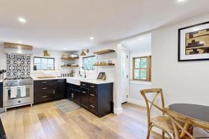 a kitchen with a table and a dining room at Sankofa Martha's Vineyard in Oak Bluffs