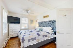 a bedroom with a bed and a flat screen tv at SEA-esta in Falmouth +12 photos