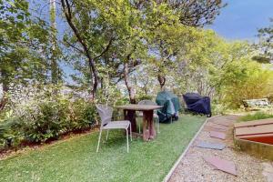 a table and chairs in a yard with tents at Endless Summer in Provincetown
