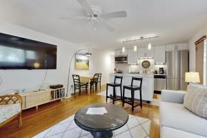 a living room and kitchen with a couch and a table at Endless Summer in Provincetown