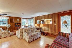 a living room with two chairs and a couch at Eastham Escape in North Eastham +19 photos