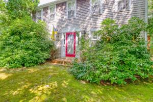 a house with a red door and some bushes at Island Oasis in Edgartown