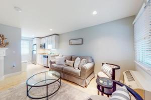 a living room with a couch and a table at Immaculate Beach Condo in Dennis Port
