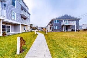 a walkway in a yard next to a house at Immaculate Beach Condo in Dennis Port