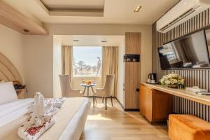 a hotel room with a bed and a table at Great Pyramid Inn in Cairo