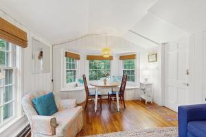 a living room with a table and chairs at Little Cozy Corner in Edgartown +14 photos