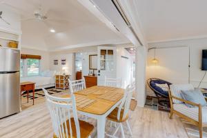 a kitchen and living room with a table and chairs at Sea House in Chatham