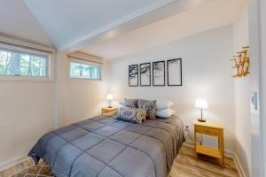 a bedroom with a large bed and two lamps at Sea House in Chatham +14 photos