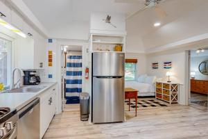 a kitchen with a stainless steel refrigerator and a bedroom at Sea House in Chatham
