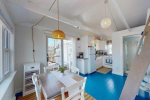 a kitchen and dining room with a table and chairs at Cottage by the Bay in Pocasset
