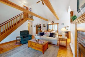 a living room with a couch and a table at The Tranquil Heron Cottage in Eastham