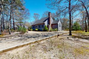 a house with a fence in front of it at The Tranquil Heron Cottage in Eastham