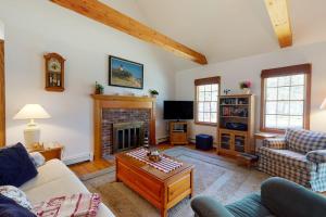 a living room with a couch and a fireplace at The Tranquil Heron Cottage in Eastham