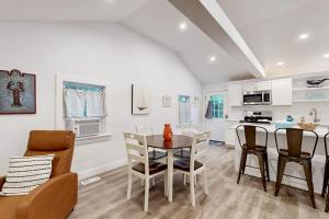 a kitchen and dining room with a table and chairs at Gateway to Cape Cod in West Yarmouth