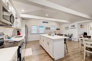 a kitchen with white cabinets and a counter top at Gateway to Cape Cod in West Yarmouth +17 photos