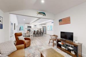 a living room with a couch and a flat screen tv at Gateway to Cape Cod in West Yarmouth
