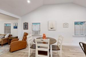 a living room with a table and chairs at Gateway to Cape Cod in West Yarmouth