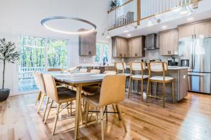 a kitchen with a dining room table and chairs at Peace Among the Pines in Wellfleet