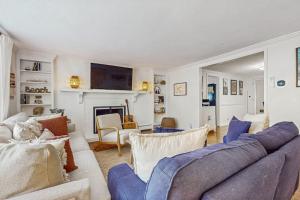 a living room with a couch and a fireplace at Strawberry Hill Haven in Hyannis