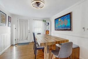 a dining room with a wooden table and chairs at Strawberry Hill Haven in Hyannis