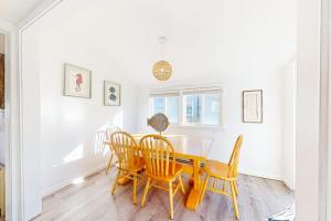 a dining room with a table and chairs at Swift Beach House in Wareham