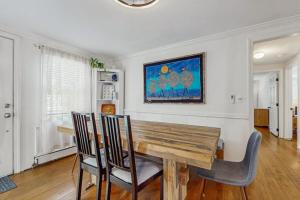 a dining room with a wooden table and chairs at Strawberry Hill Haven in Hyannis