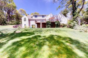 a large house with a large grassy yard at Spinnaker Trail in Orleans