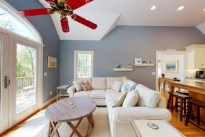 a living room with a couch and a ceiling fan at Spinnaker Trail in Orleans +39 photos