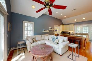 a living room with a white couch and a ceiling fan at Spinnaker Trail in Orleans