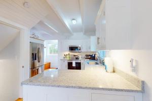 a kitchen with white cabinets and a counter top at Golden Slumbers in Bourne