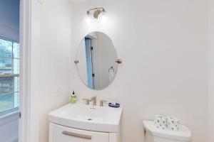 a white bathroom with a sink and a mirror at Golden Slumbers in Bourne +22 photos