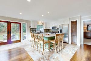 a kitchen with a table and some chairs in it at Bird's Paradise in Oak Bluffs