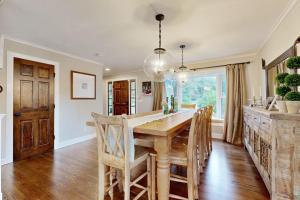 a kitchen and dining room with a wooden table and chairs at Bird's Paradise in Oak Bluffs