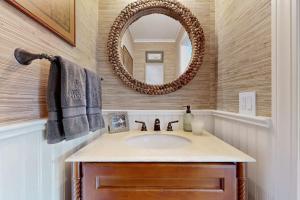 a bathroom with a sink and a mirror at Bird's Paradise in Oak Bluffs +16 photos