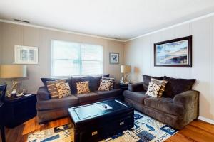 a living room with a couch and a table at Stop And Relax in Ocean Pines
