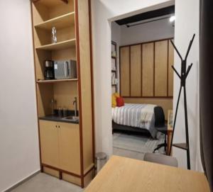 a room with a bedroom with a bed and a kitchen at Casa Tabacalera in Mexico City