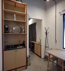 a kitchen with a counter and a table and a desk at Casa Tabacalera in Mexico City