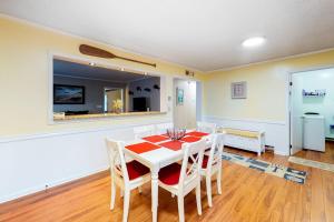 a dining room with a white table and chairs at Stop And Relax in Ocean Pines