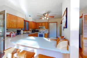a kitchen with wooden cabinets and a ceiling fan at Dove Lane 8 in Ocean Pines