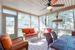 a screened in porch with furniture and a ceiling fan at Dove Lane 8 in Ocean Pines +20 photos