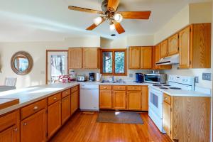 a kitchen with wooden cabinets and a ceiling fan at Dove Lane 8 in Ocean Pines