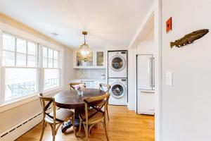 a kitchen with a table and chairs and a laundry room at Island Home in Vineyard Haven