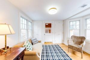 a living room with a couch and a table and windows at Island Home in Vineyard Haven +19 photos